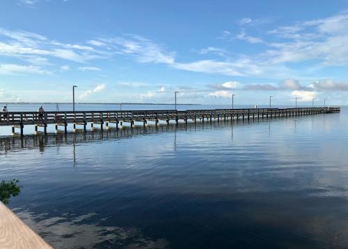 a pier on the water with people walking on it at Endless Summer Oasis in Port Charlotte