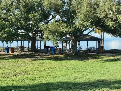 a park with trees and a pavilion and the water at Endless Summer Oasis in Port Charlotte