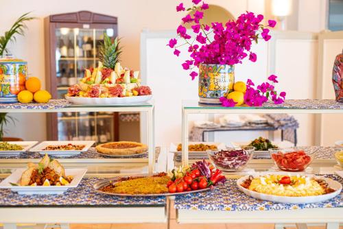 a buffet filled with different types of food at Baia Taormina - CDSHotels in Forza dʼAgro