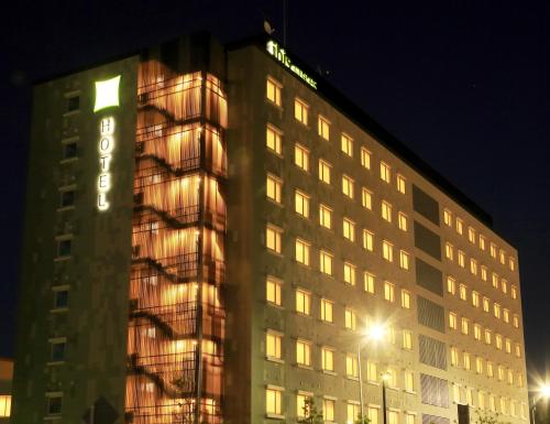 a building with a sign on it at night at ibis Styles Tokyo Bay in Urayasu