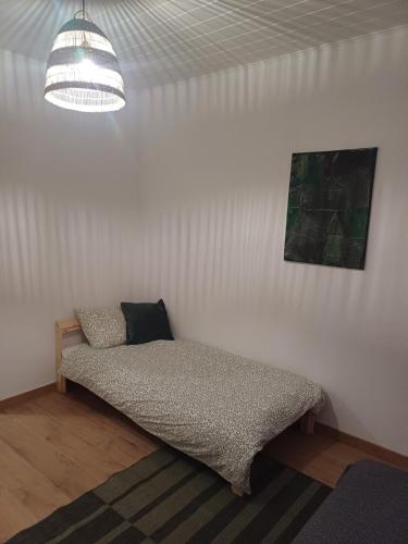 a bed sitting in a room with a ceiling at Dwór pod Sosnami Kaszuby, sauna in Ostrzyce