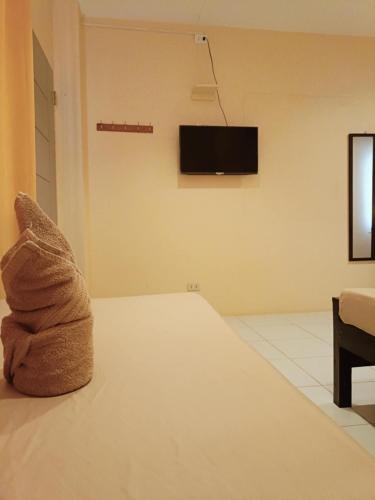 a stuffed animal sitting on the floor of a room at Claytown Pension House in Dumaguete