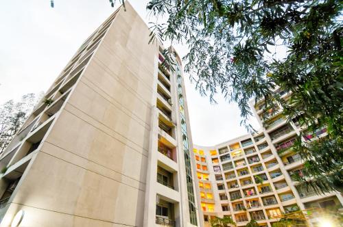 a tall building in front of a building at HOTEL Urban Asia in kolkata