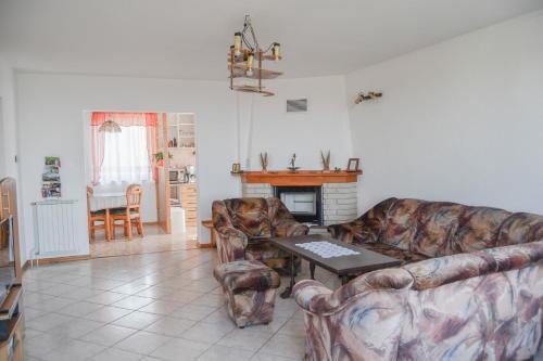 a living room with two couches and a table at Apartma Breza in Kojsko