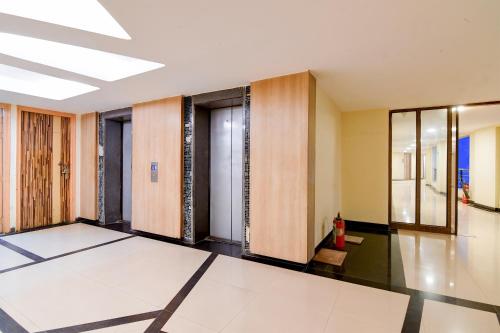 a hallway with doors and mirrors in a building at HOTEL Urban Asia in kolkata