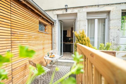 a balcony with a table on a wooden fence at L'Amour d'Or Centre Historique in Besançon