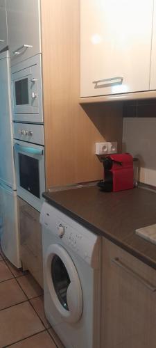 a kitchen with a washing machine and a washer at La Bordeta Serena - Casa Toño in San Juan de Plan
