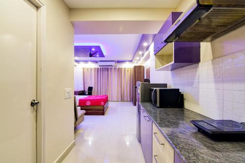 a room with a kitchen and a living room at HOTEL Urban Asia in kolkata
