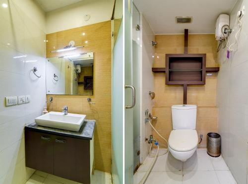a bathroom with a toilet and a sink and a shower at HOTEL Urban Asia in kolkata