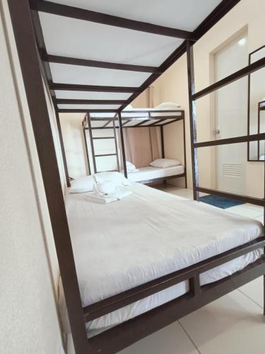 a bedroom with two bunk beds in a room at Claytown Pension House in Dumaguete