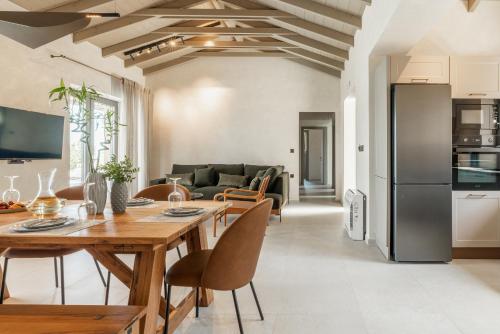 a kitchen and a living room with a table and chairs at Fiscardo Sunny Villas in Fiskardho