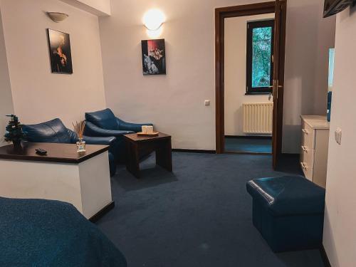 a hotel room with a bed and a table at Silvia Chalet Poiana Brasov in Poiana Brasov