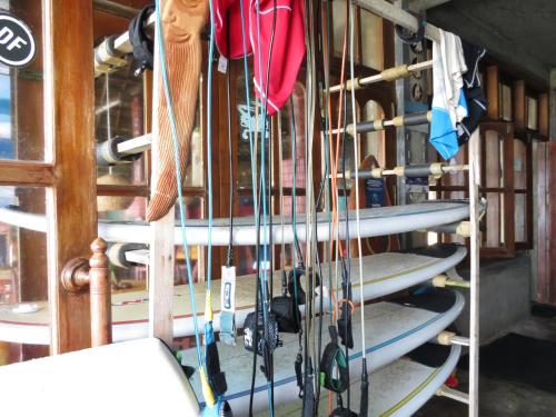 a bunch of surfboards are hanging on a rack at Why Not Guest house in Hikkaduwa
