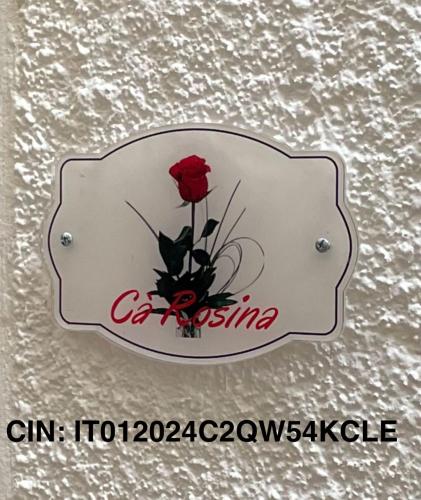 a red rose in a sign on a wall at Cà Rosina Casavacanze in Brusimpiano