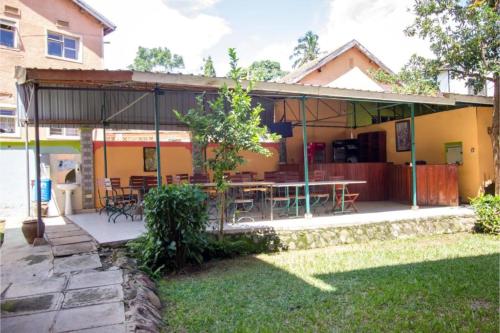a house with a patio with a table and chairs at Parkview Safari Hotel & Apartments in Kisumu