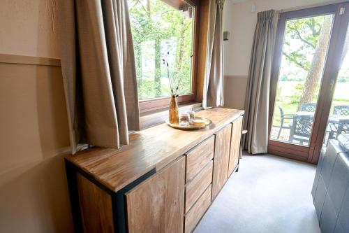 a room with a large window with a bottle on a counter at 't Eekhoornnest in Soest