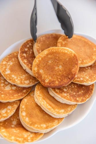 a pile of pancakes on a white plate at Palazzo Arco Cadura Hotel & Spa in Galatina