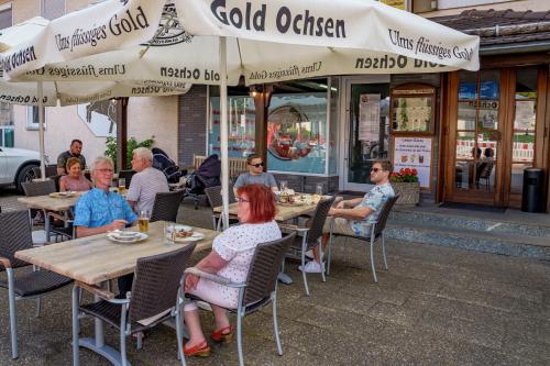 a group of people sitting at tables outside a restaurant at Landgasthof Ochsen in Neresheim
