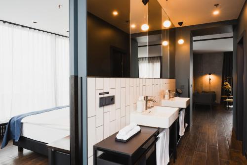 a bathroom with two sinks and a large mirror at Exeter Hotel in Reykjavík