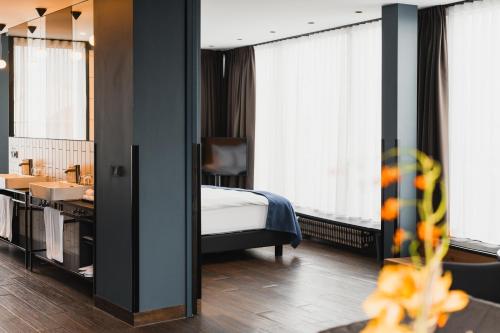 a bedroom with a bed and a sink and a mirror at Exeter Hotel in Reykjavík