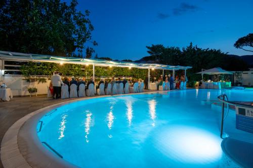 a wedding party in the pool at night at Hermitage Resort & Thermal Spa in Ischia