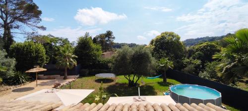 une arrière-cour avec une piscine et un jardin dans l'établissement VILLA PROVENÇALE entre ANTIBES et CANNES, à Vallauris