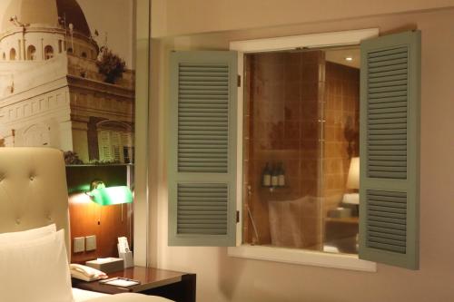 a room with a window with a building in the background at City Hotel Xiamen-Free Welcome Fruits in Xiamen