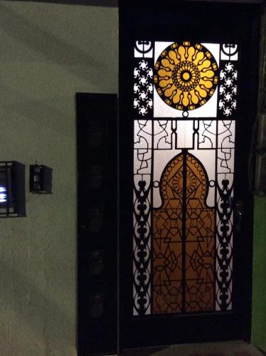 a stained glass window with a door with a flower at Heinz B. in Santa Ana de los Caballeros