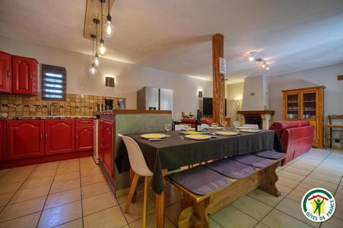 a kitchen with a table in the middle of a room at Les Platanes in Tulette