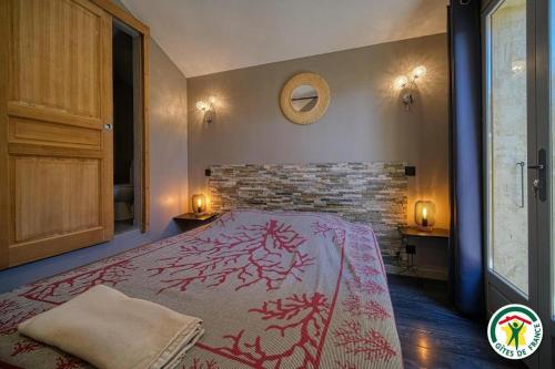 a bedroom with a bed and a brick wall at Les Platanes in Tulette