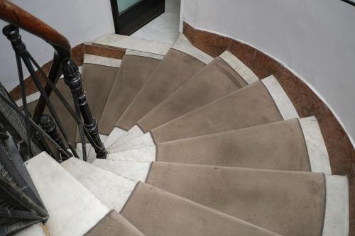 a view of a spiral stairway with a brown box at Charme Spagna Boutique Hotel in Rome
