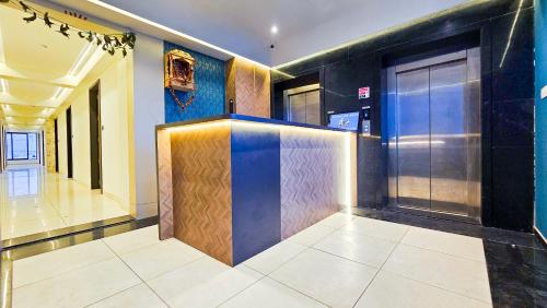 a lobby with a bar in a building at Hotel Nova Bizz in Rajkot
