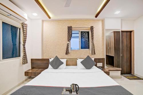 a bedroom with a large bed and a window at Townhouse Tulip in Vadodara