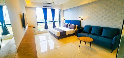 a hotel room with a bed and a couch at Hotel Nova Bizz in Rajkot