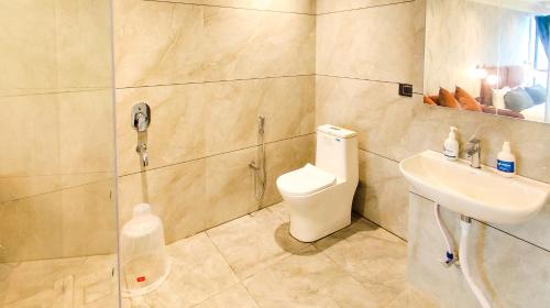 a bathroom with a toilet and a sink at Hotel Nova Bizz in Rajkot