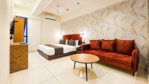 a hotel room with a bed and a couch at Hotel Nova Bizz in Rajkot