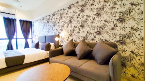 a living room with a couch and a bed at Hotel Nova Bizz in Rajkot