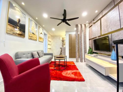a living room with a couch and a tv at Imperio Residence Melaka in Melaka