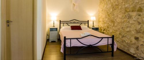 a bedroom with a bed in a room with two lamps at Adamantia Newly Built Room A4 in Gaios
