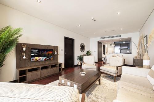 a living room with a couch and a table at Luxury Apartments in Anantara Resort with Stunning Burj AlArab & Sea Views in Dubai