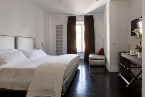 a bedroom with a bed and a dresser at Xenia Guest House in Rome