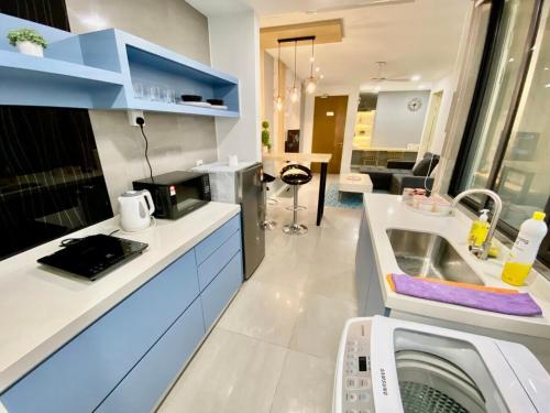 a kitchen with a sink and a washing machine at Imperio Residence Melaka in Melaka