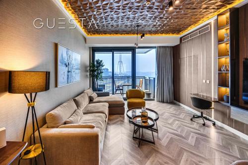 a living room with a couch and a table at 52 I 42 Tower by Emaar, Dubai Marina in Dubai