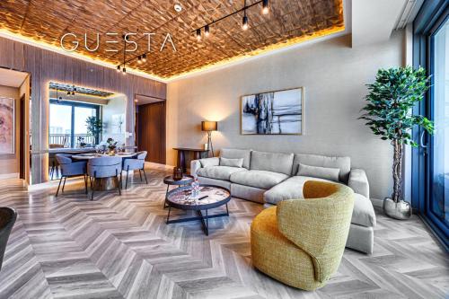 a living room with a couch and a table at 52 I 42 Tower by Emaar, Dubai Marina in Dubai