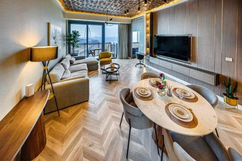 a living room with a table and a couch at 52 I 42 Tower by Emaar, Dubai Marina in Dubai