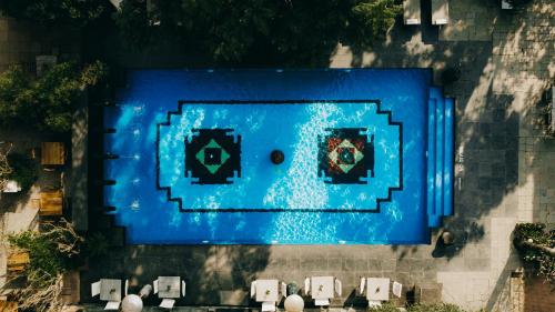 an overhead view of a pool with blue water at The Dwarika's Hotel in Kathmandu