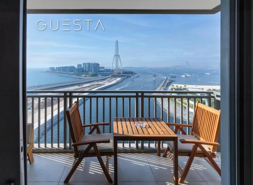 a table and chairs on a balcony with a view of the ocean at 52 I 42 Tower by Emaar, Dubai Marina in Dubai