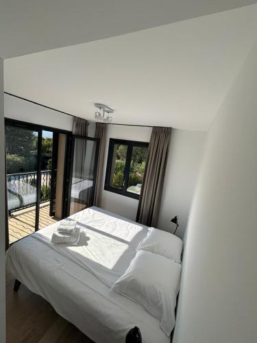 a bedroom with a large bed and a balcony at VillaGassin 380 Luxury Villa with Private Pool near Saint-Tropez - Airco-Parking in Saint-Tropez