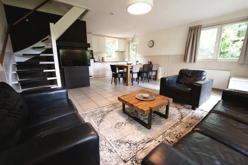 a living room with a couch and a table at 't Eekhoornnest in Soest