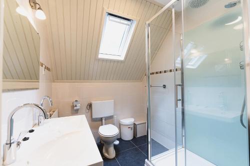 a bathroom with a shower and a toilet at 't Eekhoornnest in Soest